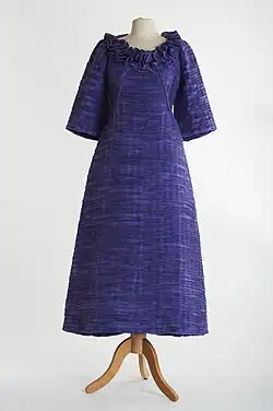 Lavender evening gown in pleated linen with 3/4 length sleeves and a frilled neckline by Sybil Connolly