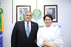 Colour photograph of Linnyer Beatrys Ruiz Aylon in 2022, wearing a suit, he is stood next an unnamed woman