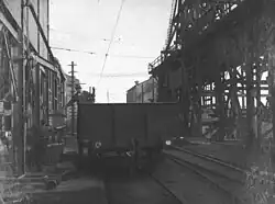 Loading copper ingots into a NSWGR wagon. Note overhead wiring for electrified railway (1912)