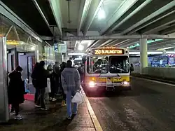 A bus at a bus platform inside a parking garage