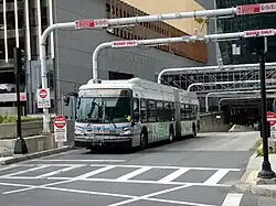 A bus waiting at a traffic signal at a tunnel portal