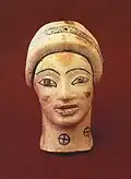 Clay figurine of a kore (young woman), dated to the second half of the 6th century B.C.