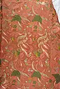 Detail of a salmon pink bizarre silk brocade mantua, c. 1708.[9] Metropolitan Museum of Art