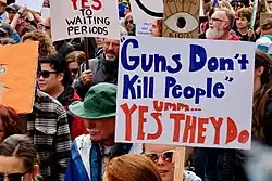 A person carrying a placard amidst a demonstration