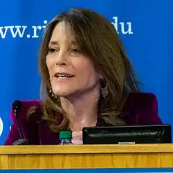 Head shot of woman speaking from a podium