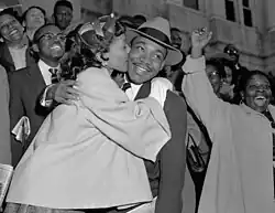 Martin Luther King Jr. is welcomed with a kiss from his wife, Coretta Scott King, after leaving court in Montgomery, AL, on March 22, 1956