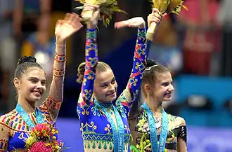 Kabaeva, Barsukova, and Raskin wave on the medal podium