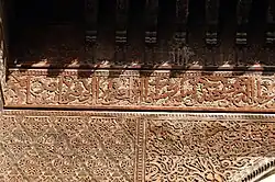 Example of wooden surfaces with ornate carved motifs at the 14th-century Sahrij Madrasa