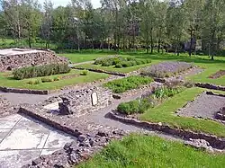 a garden with raised beds surrounded by low stone walls