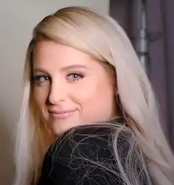 Trainor glancing over her left shoulder towards a camera