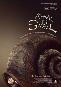 Grace Pudel peeks over inside a big snail shell.