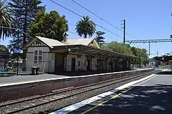 Northbound view from the former ground level Platform 2 viewing the station building, December 2013, prior to grade separation works