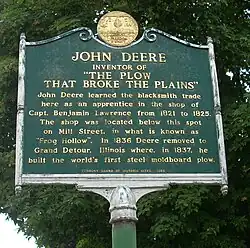 A monument in Middlebury, Vermont marking the shop in the town where John Deere learned the blacksmith trade
