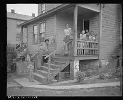 Miner's family on porch of company home at H.C. Frick Coke Company in Muse, 1946