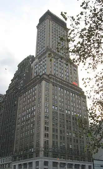 Montague–Court Building, a high-rise building clad in stone, viewed from street level