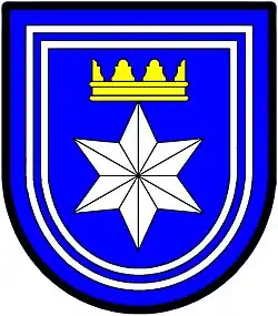 a double tressure—Azure; a facetted six pointed star [mullet] argent ensigned with a gable crown or, the whole within a double tressure argent—Langenhoven, RSA
