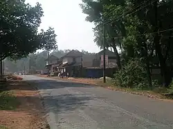 Road with utility wires and two-storey buildings