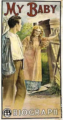 Color theatrical poster showing a man looking back at a woman leaning on a gate