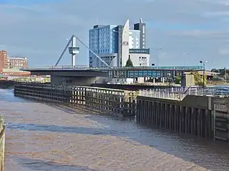 A metal bridge swung into an open position on the right hand side of the image. A river flows on the left side.