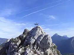 The peak is topped with a small metal cross.