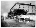 Native women selling wares under cloth shelters on Lincoln Street in Sitka