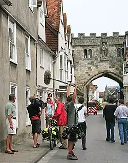 Crane (in red coat, with bicycle) filming in Salisbury, 2006