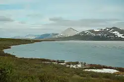 Photograph of the lake with mountains in the background