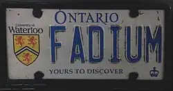 Plate with both a graphic element and a personalised registration. This example bears the logo of the University of Waterloo. The dark areas around the digits are dirt, and not part of the design.