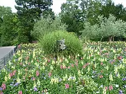 Ornamental cat in a flowerbed