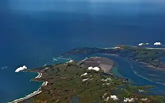 A 1200-metre-long mole at Aramoana (centre left of image), protects the mouth of New Zealand's Otago Harbour