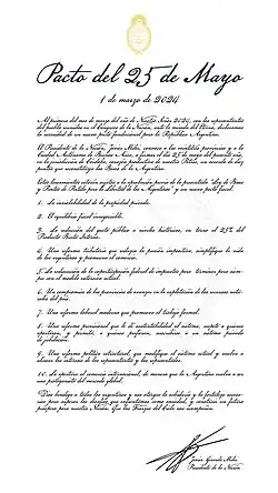 Text in a font imitating hand writing. In yellow, the coat of arms of Argentina. The text in Spanish is titled "Pacto del 25 de Mayo". The subtitle is "1 de marzo de 2024". The main text starts "Al primero del mes de marzo del año de Nuestro Señor, con los representantes del pueblo reunidos en el Congreso de la NaAción,..."