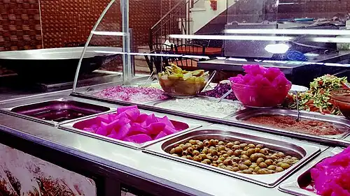 Salads, pickles, and condiments at a falafel shop in Jerusalem