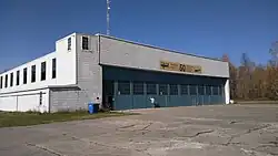 Airport hangar behind cracked pavement