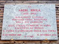 A plaque on a wall in Rome, describing Abebe's victory