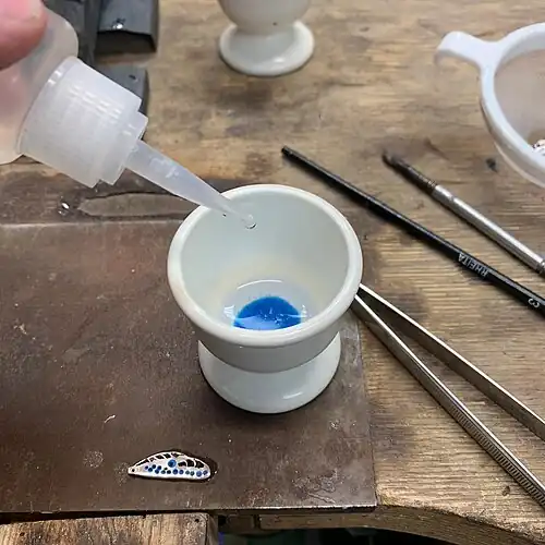 22. Minor flaws can now be fixed. Gum tragacanth is added to the wet powder to hold it in place during the final firing.