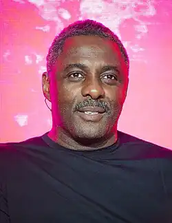 Idris Elba looks to the camera