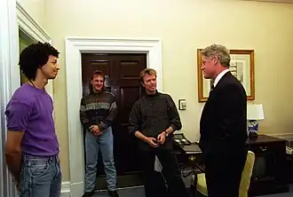 A group of men standing together in an office