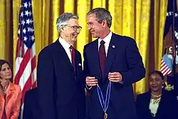 Fred Rogers smiles as he receives the award from President George W. Bush, 2002.