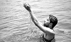 A devout dips in the water of Narmada in Kenud pond (Punasa Lift Irrigation Scheme BR-2 Kenud Pond)