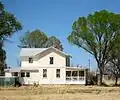 Section house for the New Mexico & Arizona Railroad, Elgin, Arizona. The railroad line ran just to the right of the large porch, approximately where the large cottonwood tree now stands.