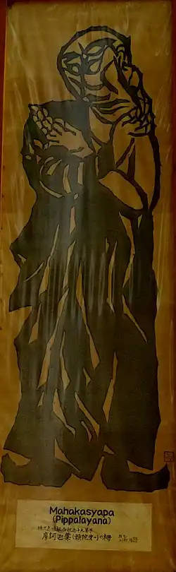 Abstract woodblock print in black ink with monk, holding his arms crossed in front of his chest