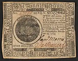 A seven-dollar banknote issued by the Second Continental Congress in 1775 with the inscription: ""SEVEN DOLLARS. THIS Bill entitles the Bearer to receive SEVEN SPANISH milled DOLLARS, or the Value thereof in Gold or Silver, according to a Resolution of CONGRESS, passed at Philadelphia November 29, 1775."; Within border cuts: "Continental Currency" and "The United Colonies".; Within circle: "SERENABIT."; Verso: "SEVEN DOLLARS. PHILADELPHIA: Printed by HALL and SELLERS. 1775."