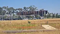 Outside view of Rockbank Station looking at station car park and concourse in the distance