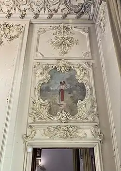 Peasant Woman with Vessel (Țărăncuță cu Cofă) by Nicolae Vermont, surrounded by Rococo Revival stuccos in the room where tickets and souvenirs are sold