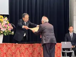Ryuko Hira being conferred the National Award of Honor by Minister of Land, Infrastructure, Transport and Tourism, Tetsuo Saito, in April 2024