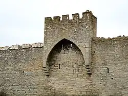 A small tower riding on the wall west of the South Gate