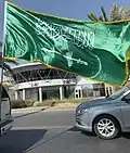 Saudi national flag mounted behind a Chevrolet Suburban, 2024