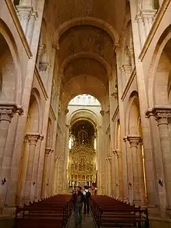Barrel vaulted nave with a high placed arched gallery.