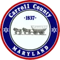 A round seal featuring a horse-drawn wagon and a red-and-blue border
