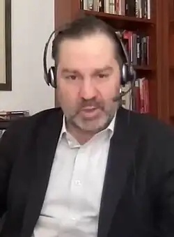 Headshot of McMeekin, who has a beard and is in a suit